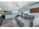 Living room with sectional sofa, hardwood floors, and built-in wet bar at 110 Surf St, New Smyrna Beach, FL 32169