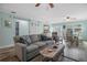 Open living room featuring a gray couch and a barn door at 110 Surf St, New Smyrna Beach, FL 32169