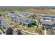 An aerial view of blue townhomes with attached garages, green lawns and well-maintained landscaping at 514 Rainbow Springs Loop, Groveland, FL 34736