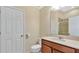 Cozy bathroom featuring vanity with solid surface counter, toilet and shower at 514 Rainbow Springs Loop, Groveland, FL 34736