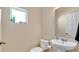 Compact bathroom with a pedestal sink, toilet, and a mirror at 514 Rainbow Springs Loop, Groveland, FL 34736