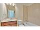 Well-lit bathroom features a single sink vanity, toilet, and shower-tub combination with tile surround at 514 Rainbow Springs Loop, Groveland, FL 34736