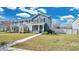 Two-story townhome boasting a covered front porch, lush lawn and beautiful landscaping adding to its curb appeal at 514 Rainbow Springs Loop, Groveland, FL 34736