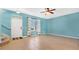 Bright and airy living room featuring tile flooring, a ceiling fan, and a large window with decorative curtains at 514 Rainbow Springs Loop, Groveland, FL 34736