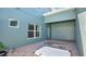 Back patio with brick pavers, featuring a covered area and windows offering bright natural light at 514 Rainbow Springs Loop, Groveland, FL 34736