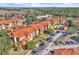 Aerial view of condo building showing building exterior, pool, and parking lot at 5512 Metrowest Blvd # 110, Orlando, FL 32811