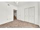 Bright bedroom with carpet flooring and double-door closet at 5512 Metrowest Blvd # 110, Orlando, FL 32811