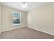 Well-lit bedroom with ceiling fan and carpet at 5512 Metrowest Blvd # 110, Orlando, FL 32811