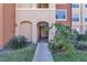 Condo building entryway with lush landscaping and walkway at 5512 Metrowest Blvd # 110, Orlando, FL 32811