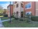 Condo building entrance with landscaping and walkway at 5512 Metrowest Blvd # 110, Orlando, FL 32811