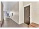 Interior hallway with a dark brown door and metal staircase at 5512 Metrowest Blvd # 110, Orlando, FL 32811