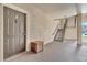 Interior hallway with a dark brown door and metal staircase at 5512 Metrowest Blvd # 110, Orlando, FL 32811