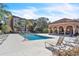 Community pool with lounge chairs and a covered patio at 5512 Metrowest Blvd # 110, Orlando, FL 32811