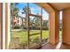 Screened-in porch overlooking a grassy yard and community at 5512 Metrowest Blvd # 110, Orlando, FL 32811