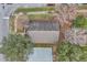 Aerial view of house roof and surrounding trees at 6621 Bouganvillea Crescent Dr, Orlando, FL 32809