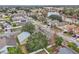 Aerial view of a residential neighborhood with houses and a lake at 6621 Bouganvillea Crescent Dr, Orlando, FL 32809