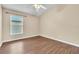 Bedroom with wood-look floors and large window at 6621 Bouganvillea Crescent Dr, Orlando, FL 32809