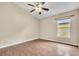 Bright bedroom with wood-look floors and ceiling fan at 6621 Bouganvillea Crescent Dr, Orlando, FL 32809