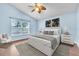 Bright bedroom with light walls, ceiling fan and wood-look floors at 6621 Bouganvillea Crescent Dr, Orlando, FL 32809