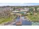 Wooden community dock extending over a lake with lush vegetation at 6621 Bouganvillea Crescent Dr, Orlando, FL 32809