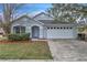 One-story house with a two-car garage and well-maintained landscaping at 6621 Bouganvillea Crescent Dr, Orlando, FL 32809