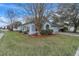 House with mature trees and manicured lawn in front at 6621 Bouganvillea Crescent Dr, Orlando, FL 32809