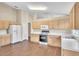 Light wood cabinets and vinyl flooring in this open kitchen at 6621 Bouganvillea Crescent Dr, Orlando, FL 32809