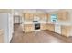 Kitchen with light wood cabinets, and a full set of appliances at 6621 Bouganvillea Crescent Dr, Orlando, FL 32809