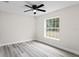 Bedroom with ceiling fan, large window, and gray flooring at 258 Fraser Rd, Debary, FL 32713