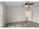 Bright bedroom with ceiling fan, large window, and access to hallway at 258 Fraser Rd, Debary, FL 32713