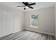 Bright bedroom with grey vinyl flooring and a double door closet at 258 Fraser Rd, Debary, FL 32713