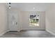 Bright entryway with white door, grey flooring, and a view to the street at 258 Fraser Rd, Debary, FL 32713