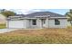 Newly built one-story house featuring gray siding, a white door, and stone accents at 258 Fraser Rd, Debary, FL 32713