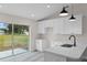 Bright kitchen featuring white cabinets, quartz countertops, and backyard view at 258 Fraser Rd, Debary, FL 32713