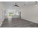 Open concept living room with grey vinyl flooring and a view into the kitchen at 258 Fraser Rd, Debary, FL 32713