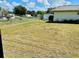 Large backyard with a shed and partially mowed grass at 34136 Carl Rd, Leesburg, FL 34788