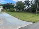 Front yard with a driveway and grassy area at 34136 Carl Rd, Leesburg, FL 34788