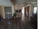 Spacious living room featuring vinyl flooring and a view into the kitchen at 34136 Carl Rd, Leesburg, FL 34788