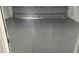 Newly finished garage floor with epoxy coating in speckled gray finish at 17139 Sw 44Th Cir, Ocala, FL 34473