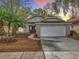 Charming single-story home featuring a well-maintained front yard with a two-car garage at sunset at 1945 Piedmont Park Blvd, Apopka, FL 32703