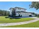 White two-story house with a three-car garage and a beautifully landscaped yard at 1948 Rowena Ave, Orlando, FL 32803