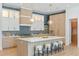 Stunning kitchen with island seating, blue backsplash, and designer lighting at 1948 Rowena Ave, Orlando, FL 32803