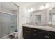 Nicely appointed bathroom with double sink vanity and glass enclosed shower at 4694 Monica St, The Villages, FL 32163