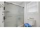 Clean bathroom features glass enclosed shower, toilet and window with blinds at 4694 Monica St, The Villages, FL 32163
