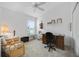 Comfortable bedroom with ceiling fan, workspace, and large closet at 4694 Monica St, The Villages, FL 32163