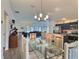 Bright dining area with stylish chandelier open to living room and kitchen, great for entertaining at 4694 Monica St, The Villages, FL 32163