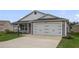 Charming single-story home featuring a two-car garage, well-maintained lawn, and neutral gray siding at 4694 Monica St, The Villages, FL 32163