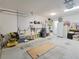 Spacious garage with pegboard wall, storage, and ample workspace at 4694 Monica St, The Villages, FL 32163