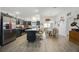 Modern kitchen with stainless steel appliances, a center island, and adjacent dining area, perfect for entertaining at 4694 Monica St, The Villages, FL 32163