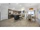 Modern kitchen featuring stainless steel appliances, a spacious island, and a dining area at 4694 Monica St, The Villages, FL 32163